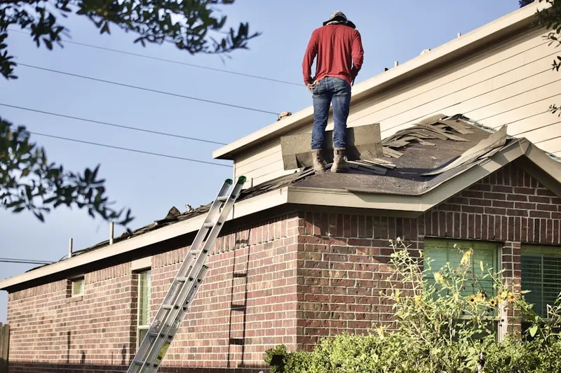 Professional roofer working on a residential roof in Indian Crossing